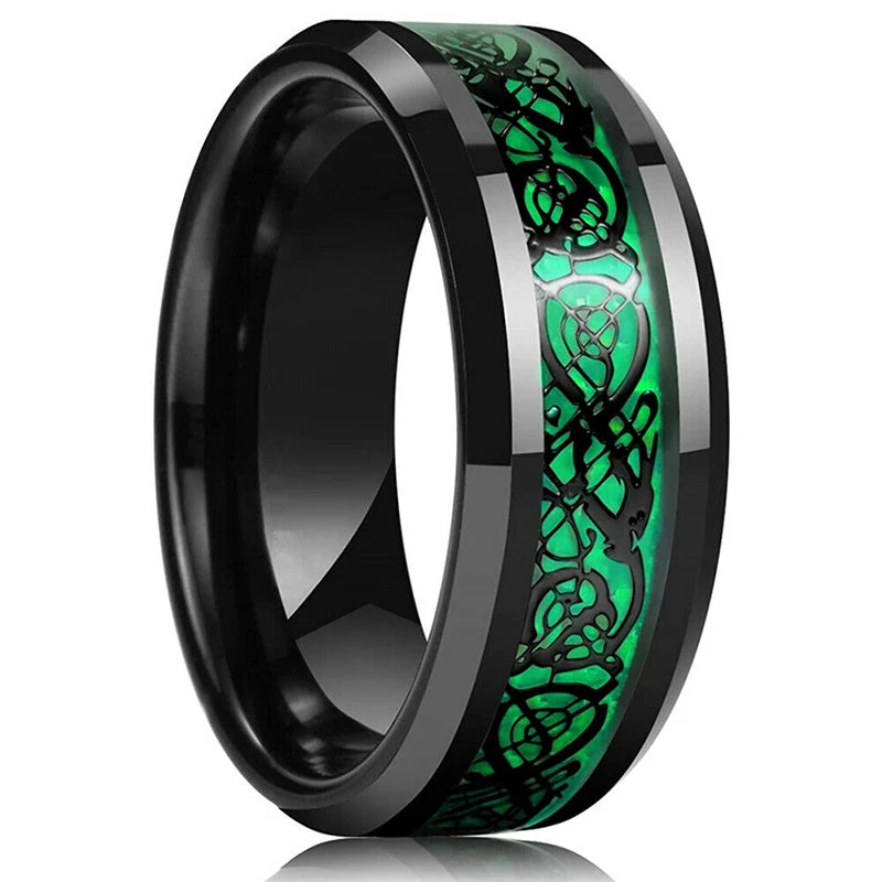 Black ring with green Celtic knot design on a white background