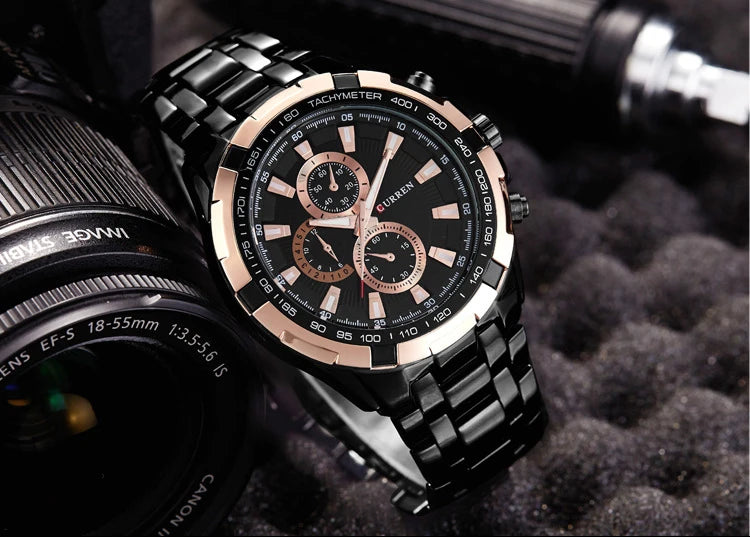 Luxury watch with black and rose gold design on a textured surface