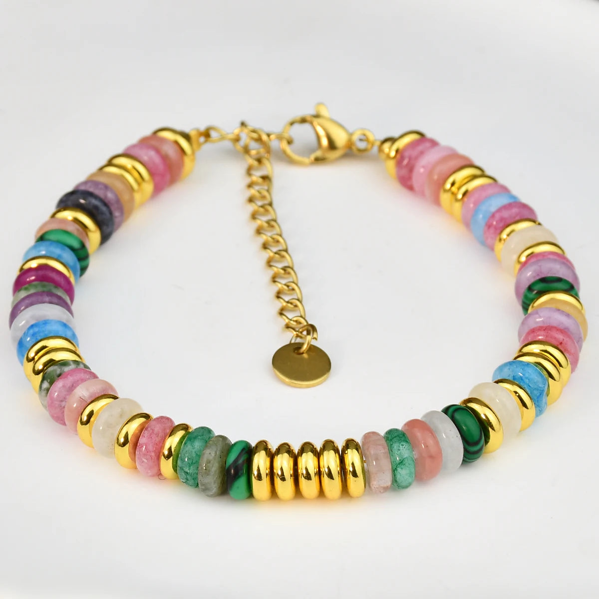 Multicolored beaded bracelet with gold accents on a white background