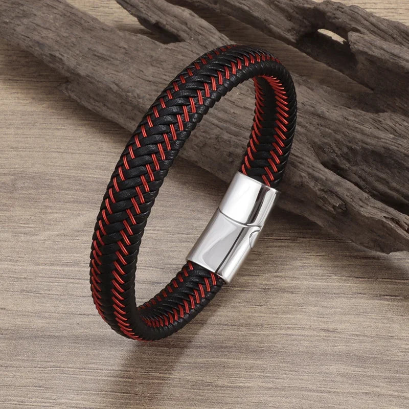 Black and red braided bracelet with a silver clasp on a wooden surface