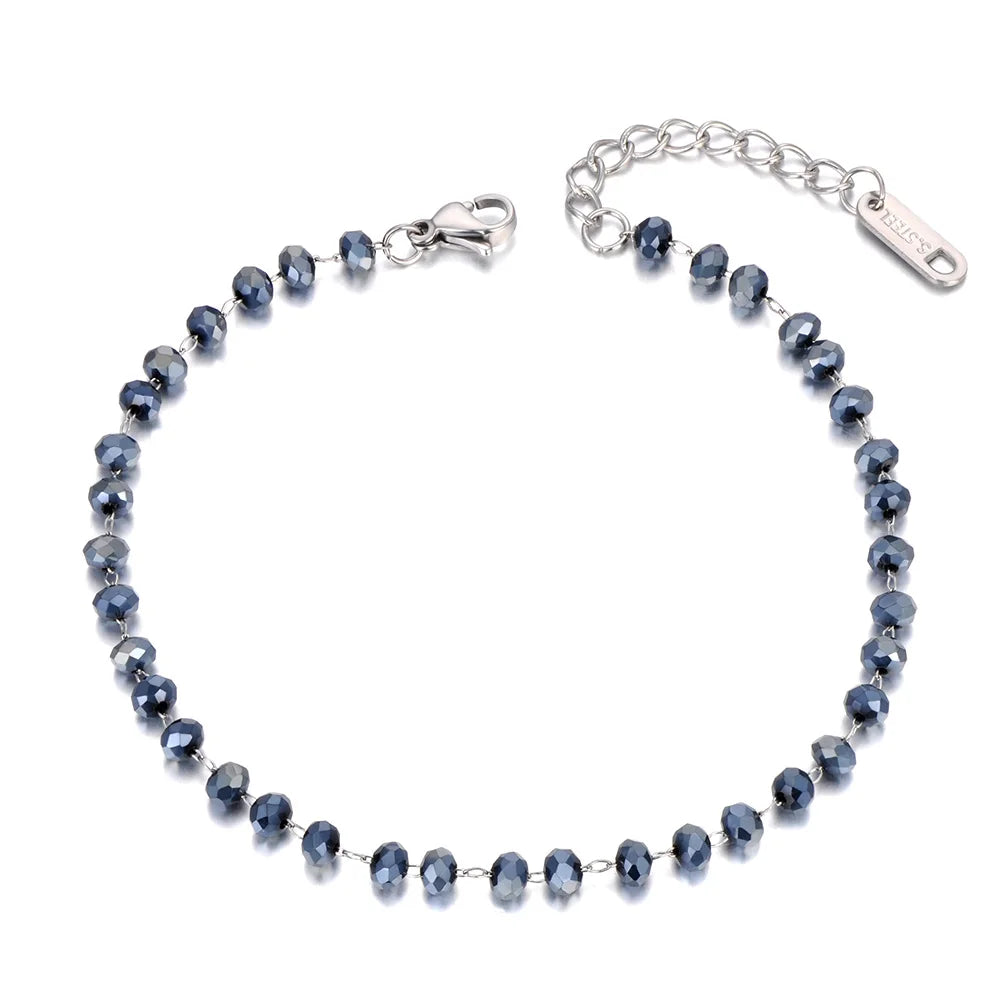 Silver bracelet with blue beads on a white background