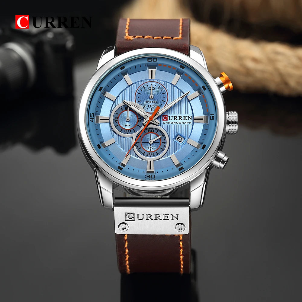 Curren watch with blue face and brown leather strap on a dark background