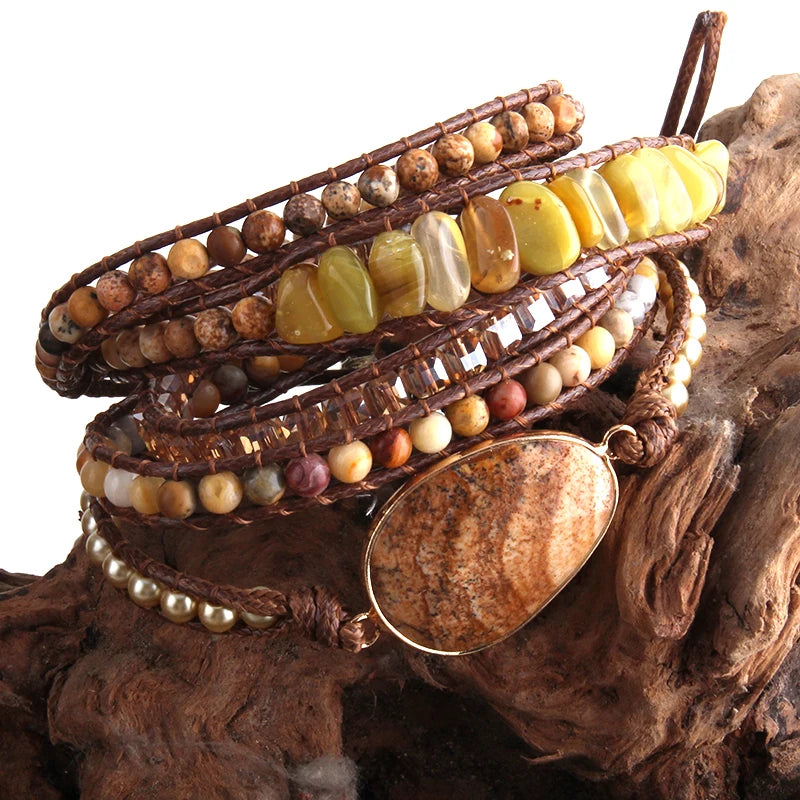 Multistrand beaded bracelet with a large round stone on a wooden surface
