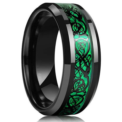 Black ring with green Celtic knot design on a white background
