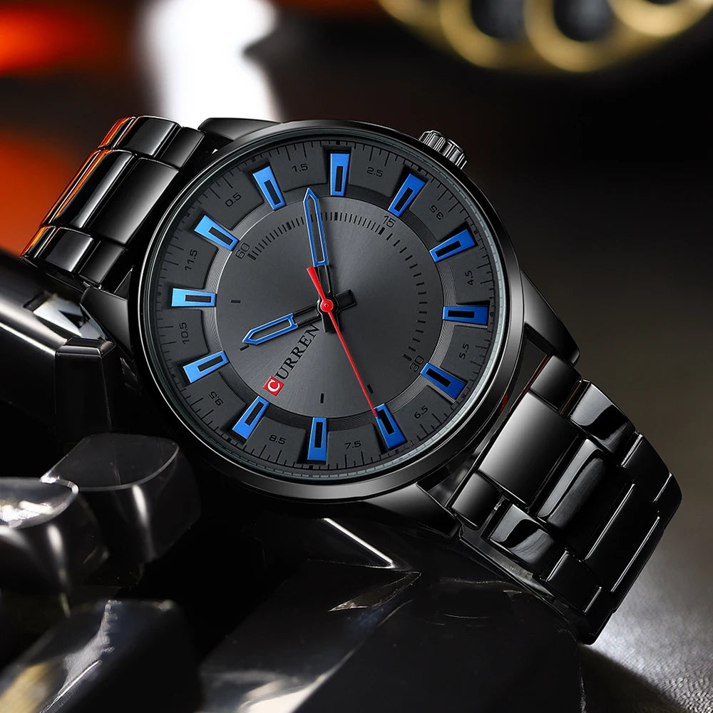 Black wristwatch with blue and red accents on a dark background