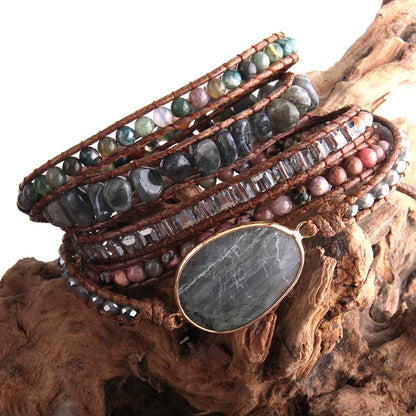 Stack of beaded bracelets on a wooden surface