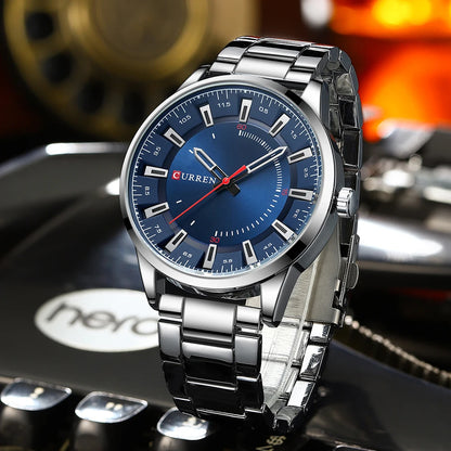 Silver watch with blue dial on a blurred background