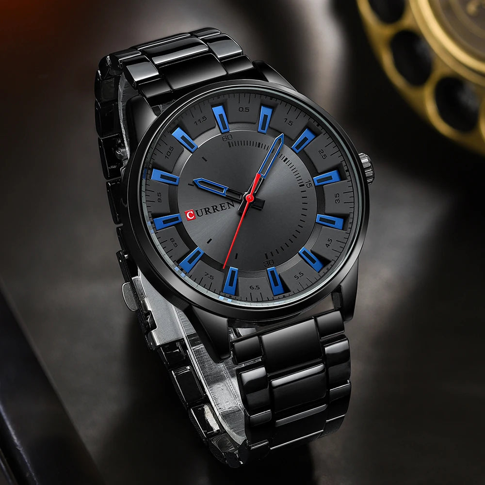Black wristwatch with blue hour markers on a dark background