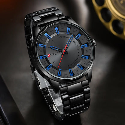 Black wristwatch with blue hour markers on a dark background