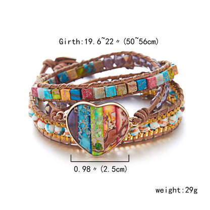 Multicolored beaded bracelet with heart-shaped charm on a white background