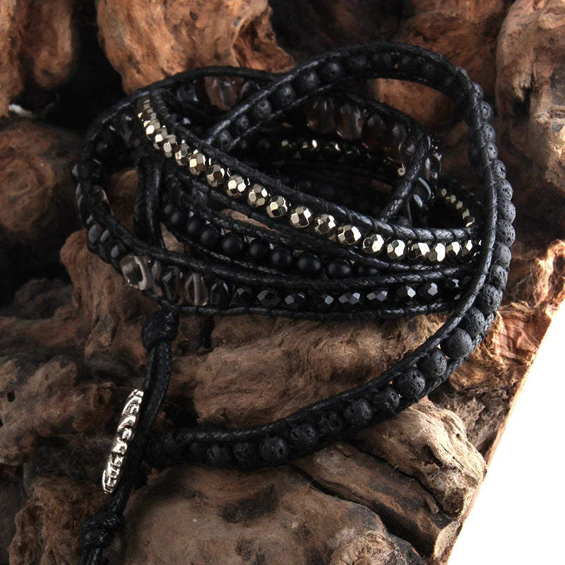 Black beaded bracelet on a textured stone surface