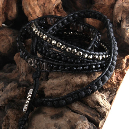 Black beaded bracelet on a textured stone surface