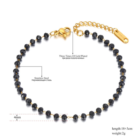 Black beaded bracelet with gold plating on a white background