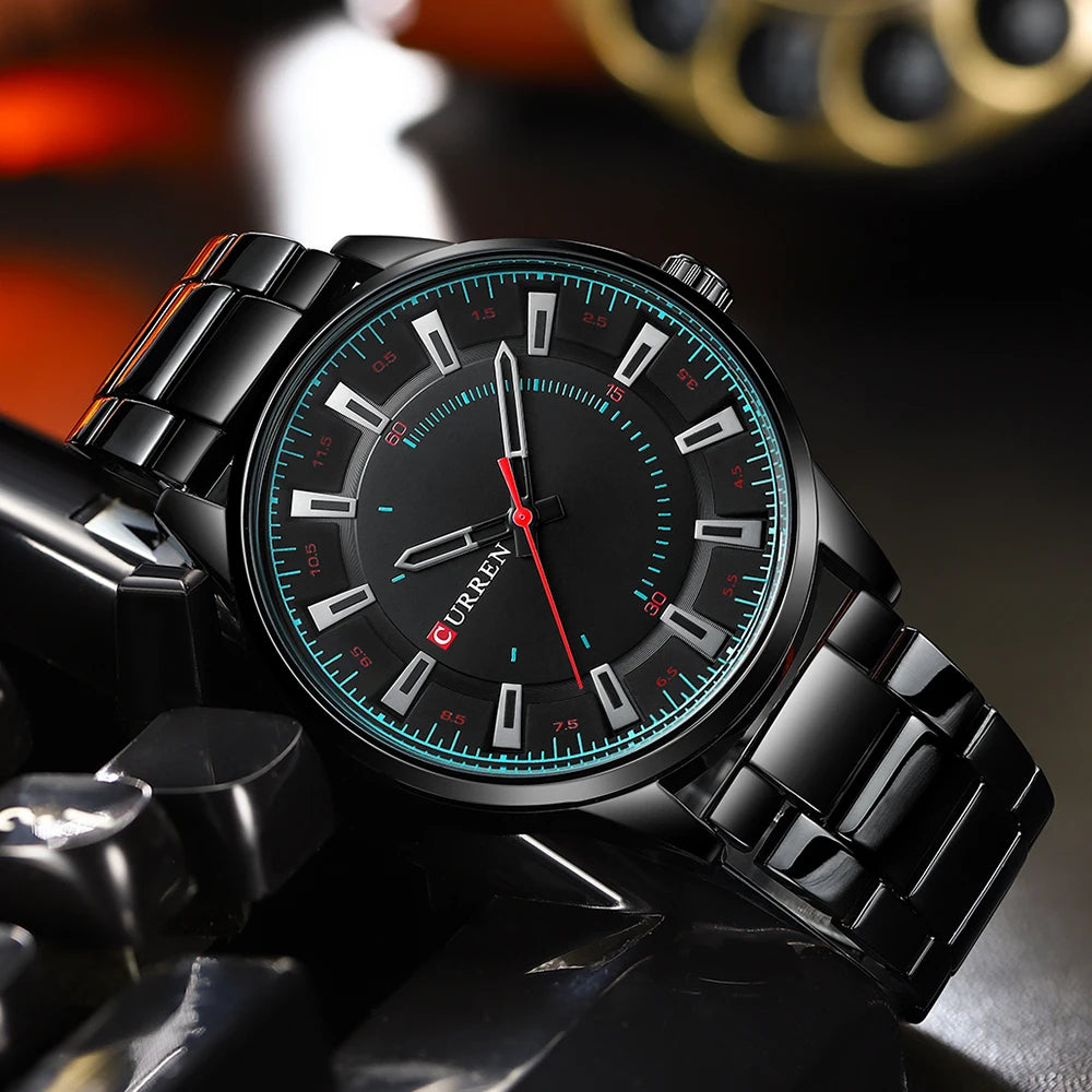 Black wristwatch with a detailed face on a motorcycle handlebar