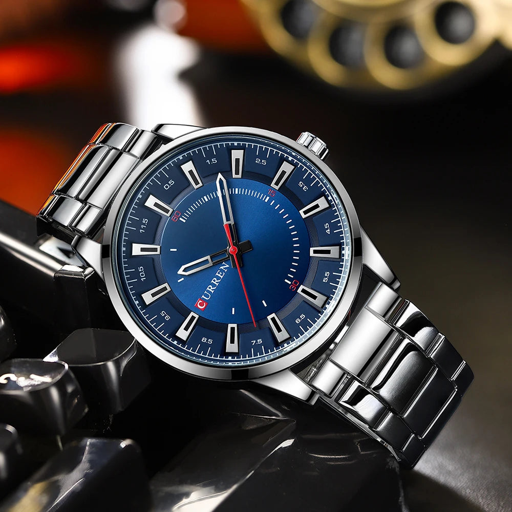 Silver watch with a blue face on a motorcycle background