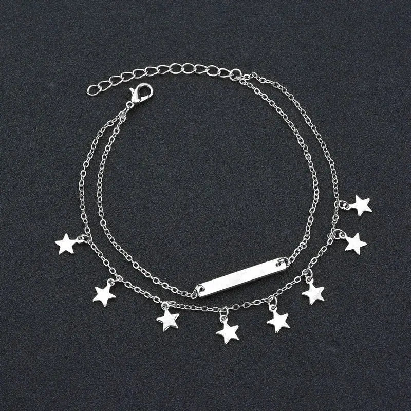 Silver bracelet with star charms on a dark background