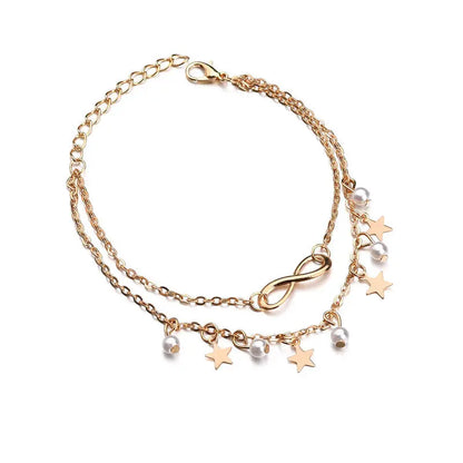 Gold bracelet with star and infinity charm on a white background