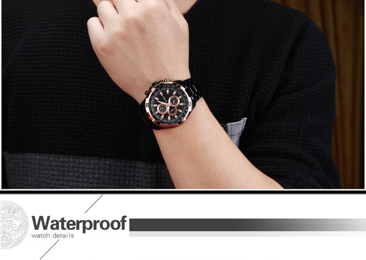 Person wearing a black wristwatch with a blurred background