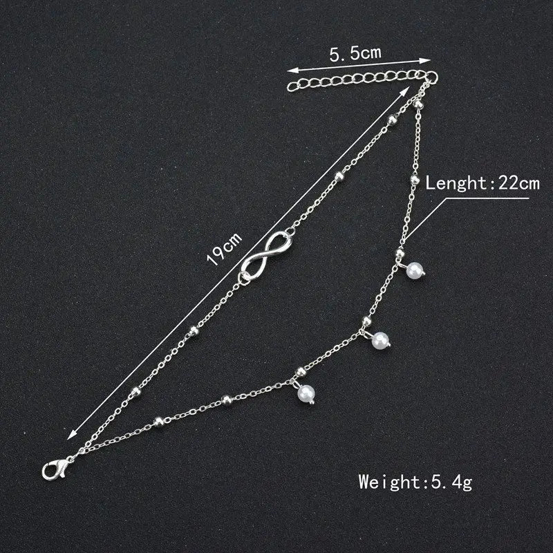 Silver bracelet with measurements on a black background
