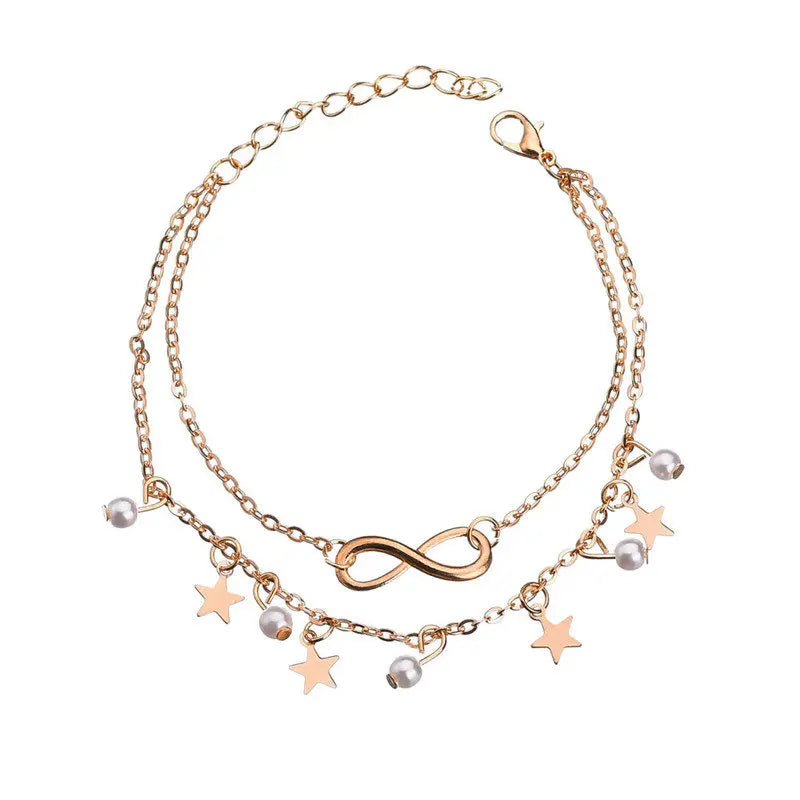 Rose gold bracelet with star and infinity charm on a white background