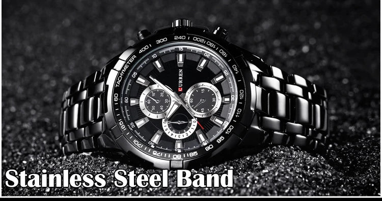 Black wristwatch with stainless steel band on a dark textured background