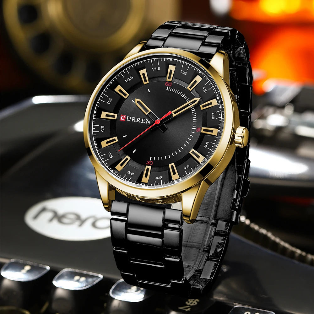 Black and gold watch with 'Curren' brand on a blurred background