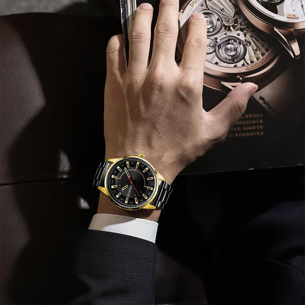 Hand wearing a gold watch with intricate mechanical details in the background