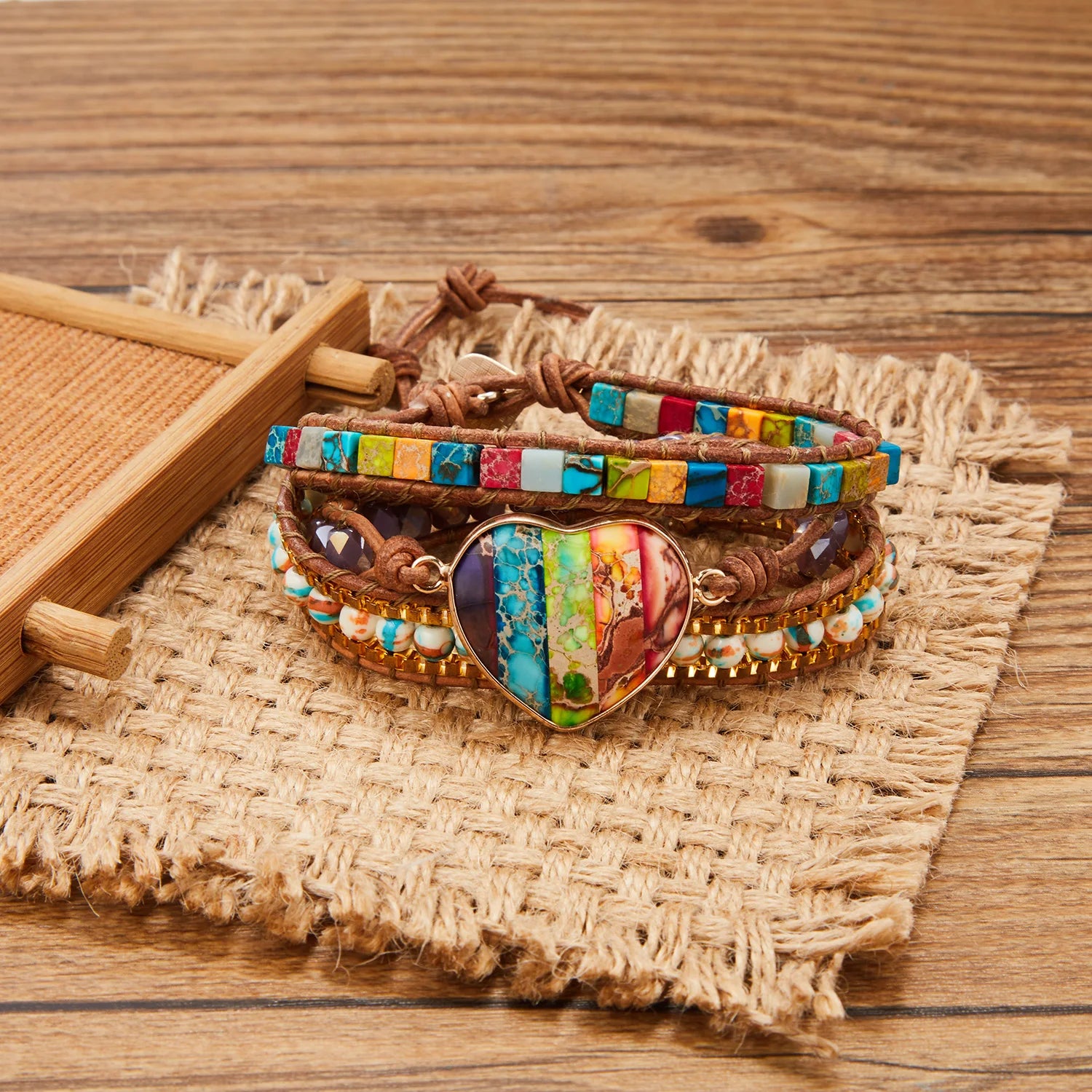 Colorful bracelet with heart-shaped charm on a woven mat