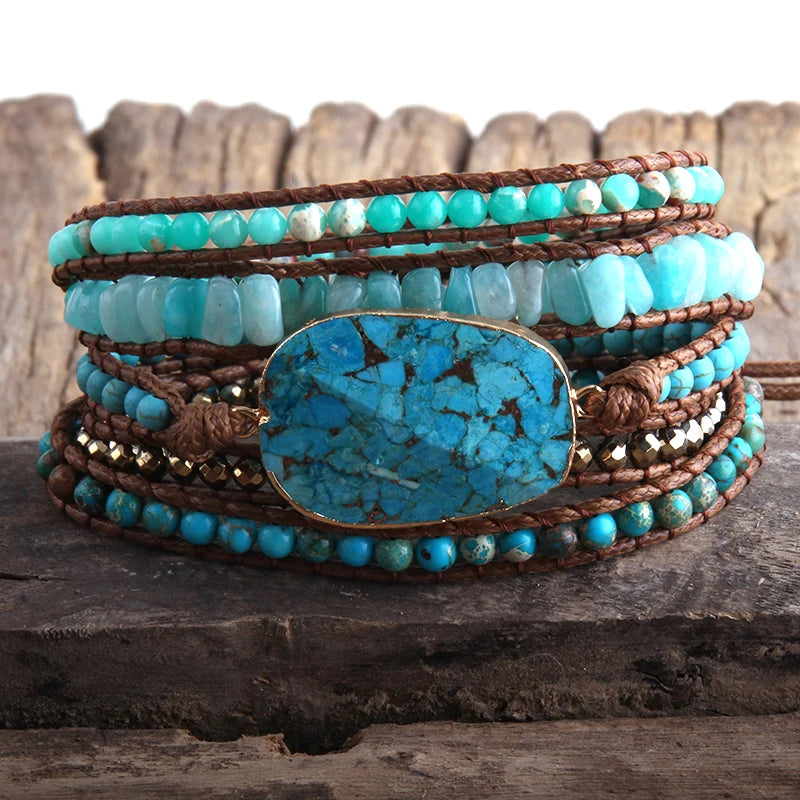 Turquoise beaded bracelet with a large turquoise stone on a wooden surface