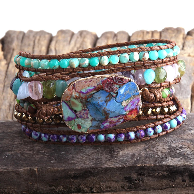 Multistrand beaded bracelet with a large turquoise stone on a wooden surface