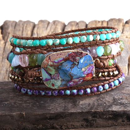 Multistrand beaded bracelet with a large turquoise stone on a wooden surface