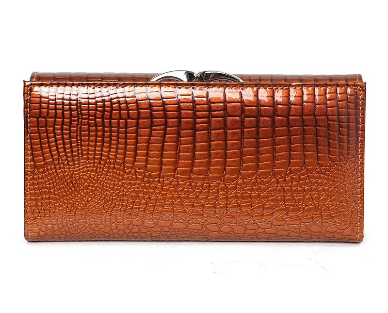 Brown crocodile-patterned clutch bag on a white background