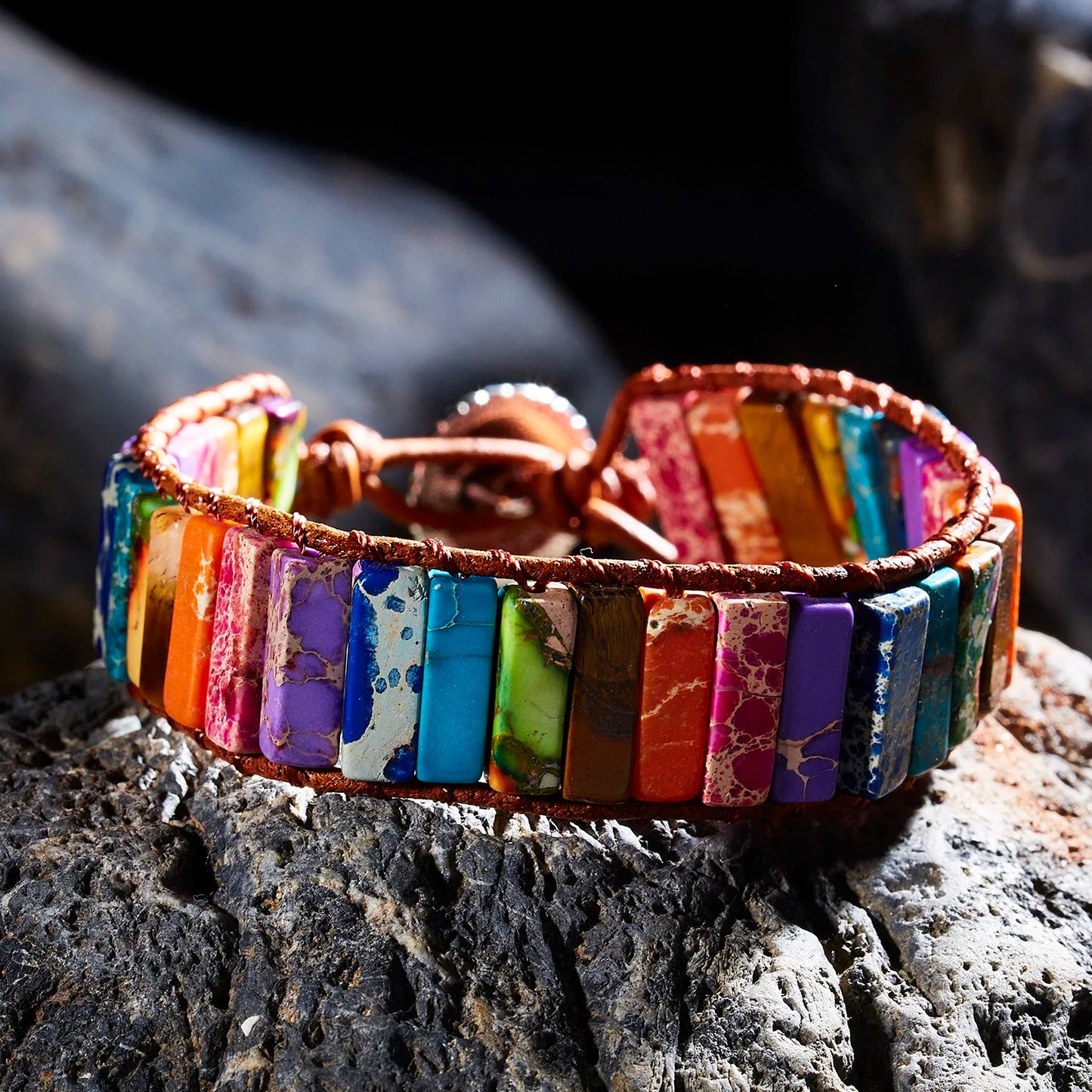 Multicolored beaded bracelet on a dark stone surface