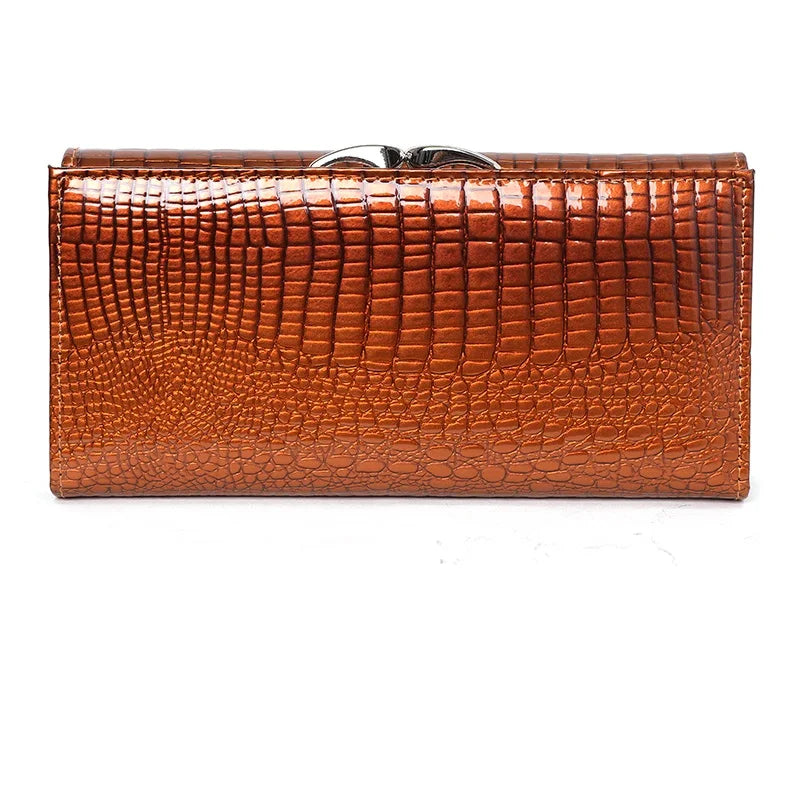 Brown crocodile-textured clutch bag on a white background