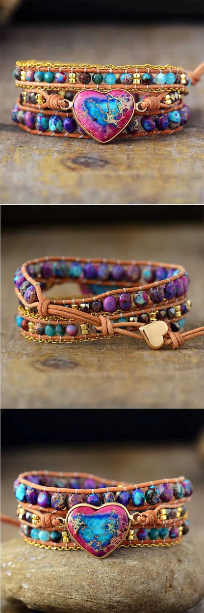 Colorful beaded bracelet with a heart-shaped charm on a stone surface