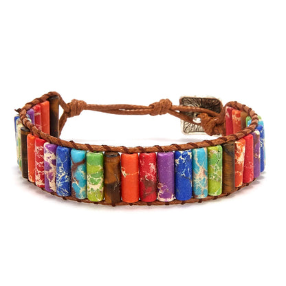 Multicolored stone bracelet with brown leather strap on a white background