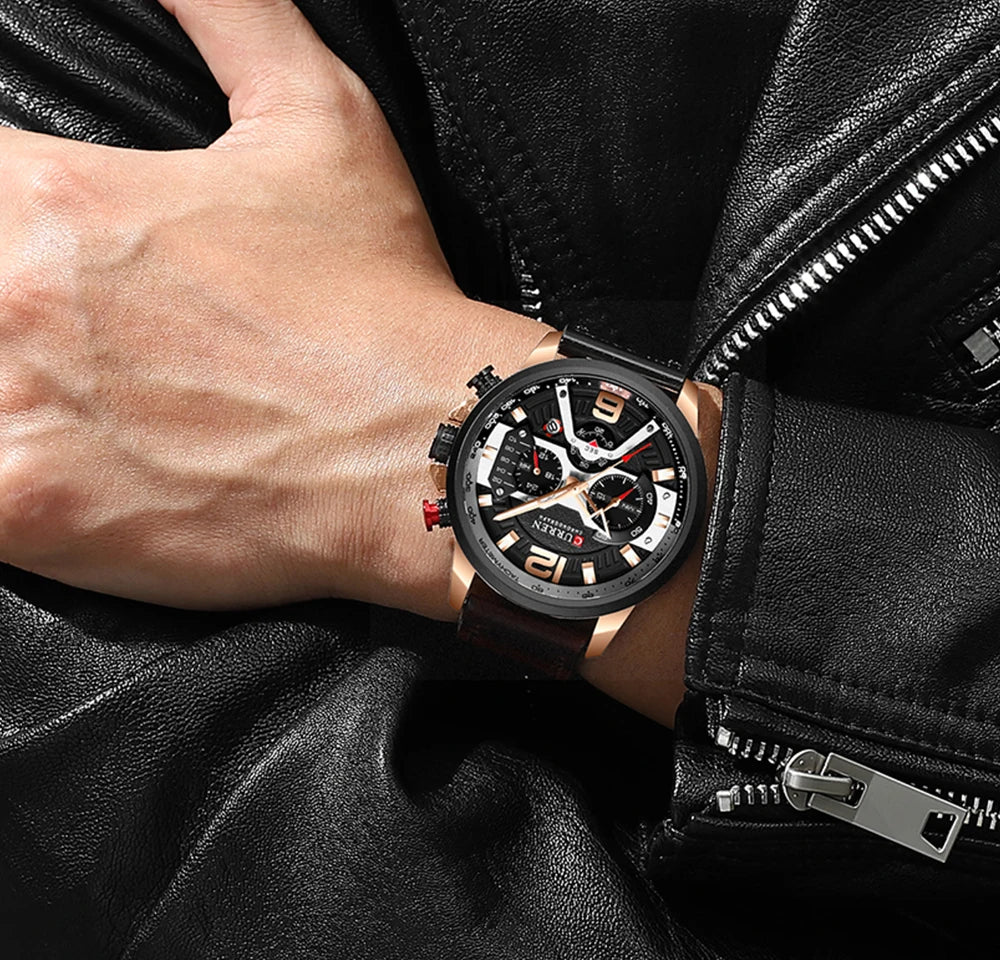 Person wearing a black wristwatch with a detailed face on a black leather jacket background