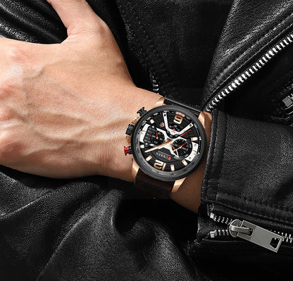 Person wearing a black wristwatch with a detailed face on a black leather jacket background