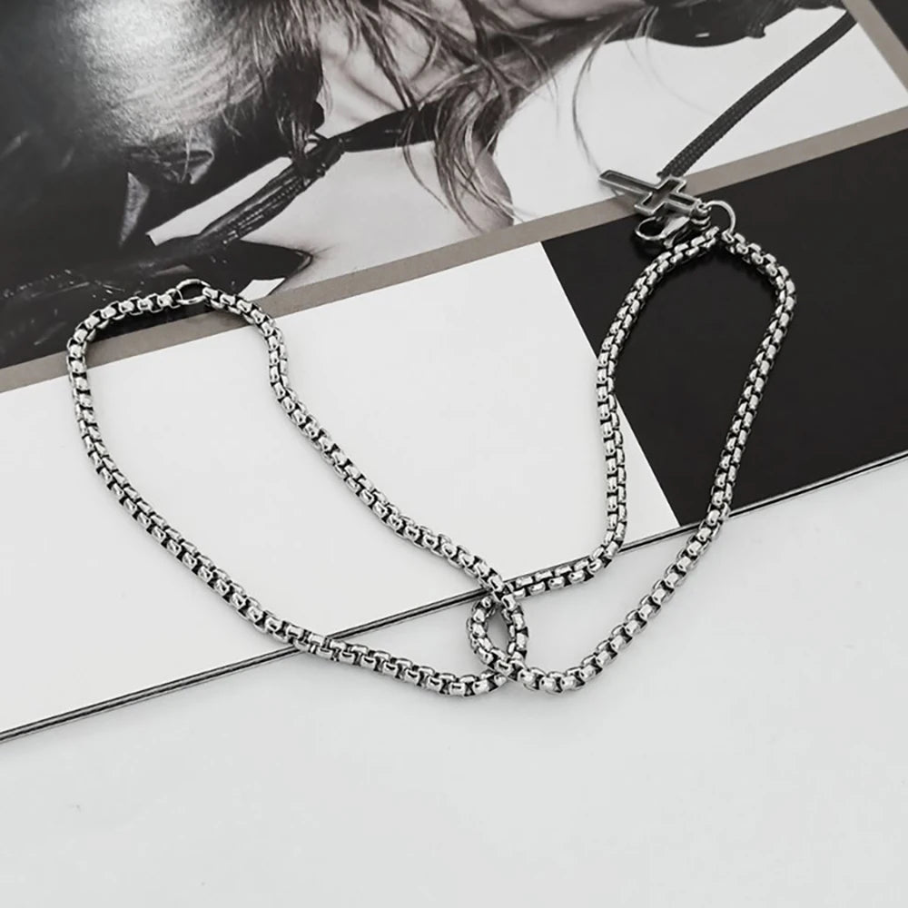 Silver chain necklace on a magazine with blurred background