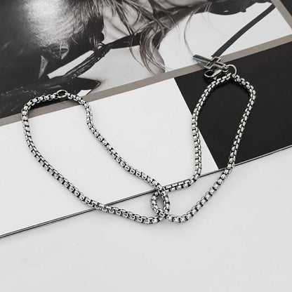 Silver chain necklace on a magazine with blurred background