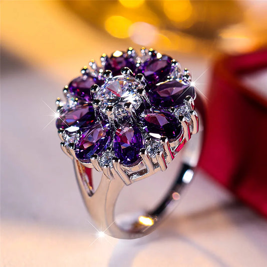 Elegant ring with purple gemstones on a blurred background