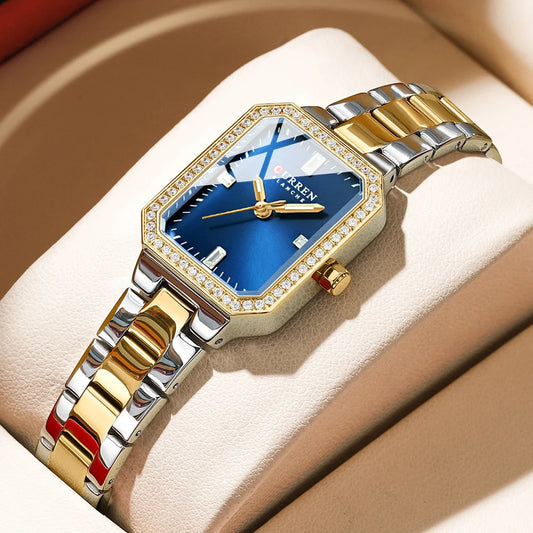 Luxury watch with gold and silver band on a beige cushion