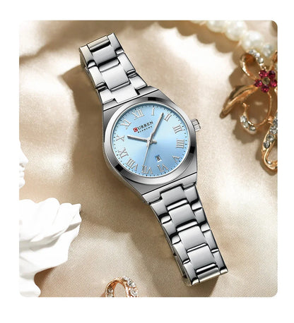 Silver watch with a blue face on a decorative background