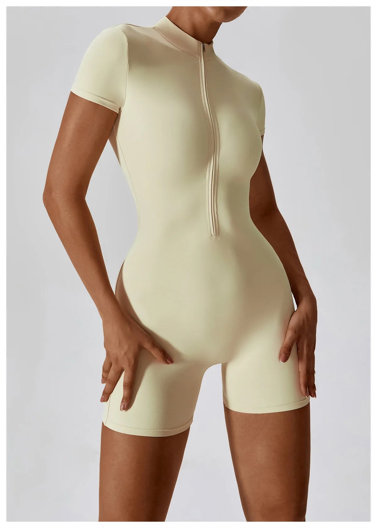Beige bodysuit with a zipper on a plain background