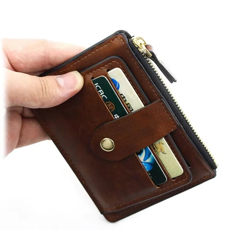 Brown leather wallet with zipper held open by a hand, showing cards inside.