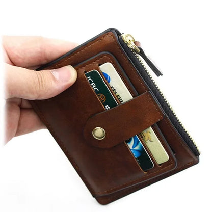 Brown leather wallet with zipper held open by a hand, showing cards inside.