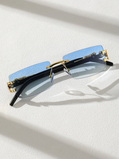 Sunglasses with blue lenses and gold frames on a white surface