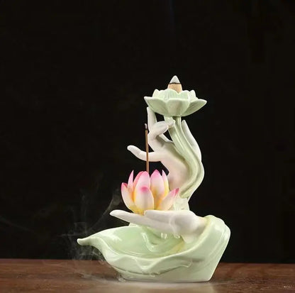 Ceramic incense burner with lotus design on a dark background