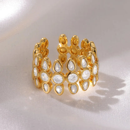 Gold ring with white stones on a light background