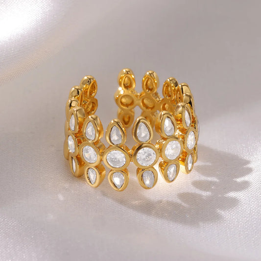 Gold ring with white stones on a light background